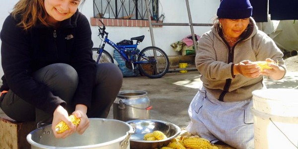 An intern on a global citizenship program in the Andes of Ecuador works on a project with children and adults